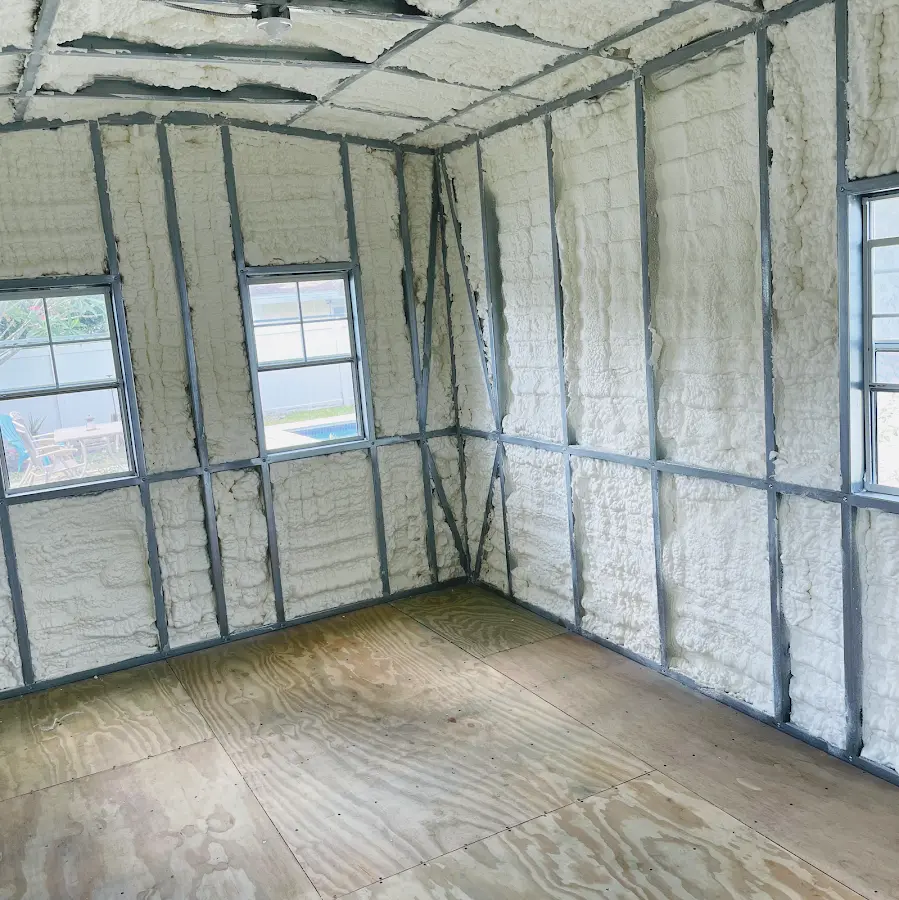 Closed-cell spray foam insulation applied to wall cavities in a residential project in Jericho